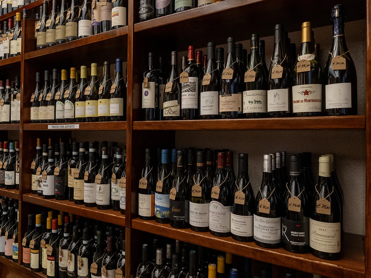Scaffali dell’enoteca con una ricca selezione di bottiglie